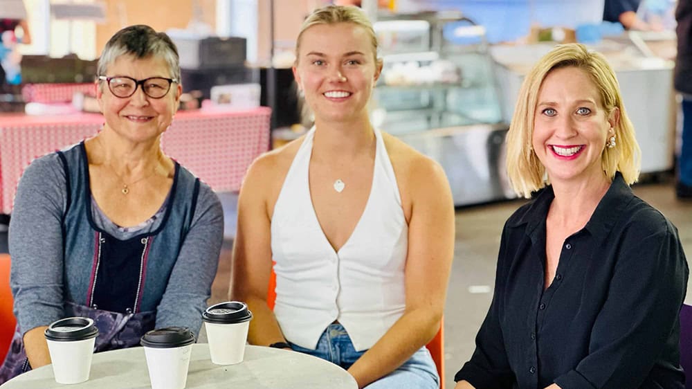 CDE Jane Giles, Molly Brooksby and Justine Cain sit at a table in Adelaide having coffees.