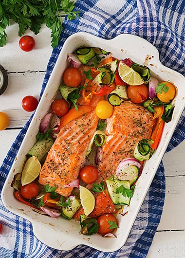 Baked salmon fillet with vegetables. Top view