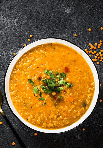 carrot and lentil soup on a black background