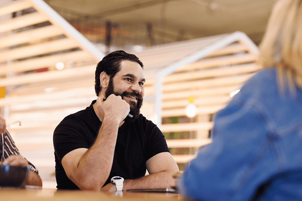 man smiling hand under chin