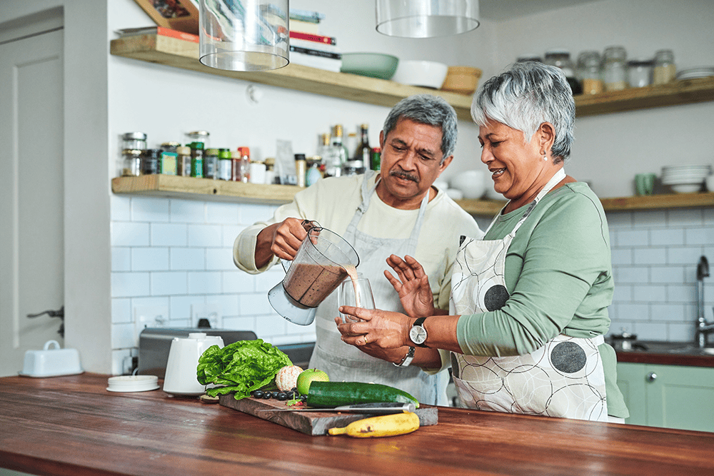 older couple cooking together in kitchen